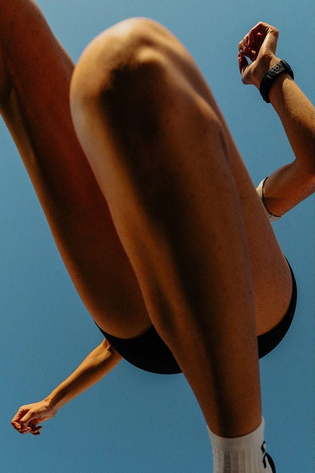 Person running with a clear blue sky background